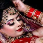Close-up of an Indian bride showcasing ornate jewelry and vibrant traditional attire.